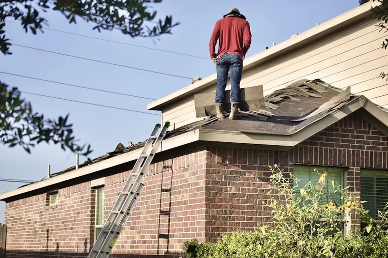Professional roofer working on a residential roof in South Orleans